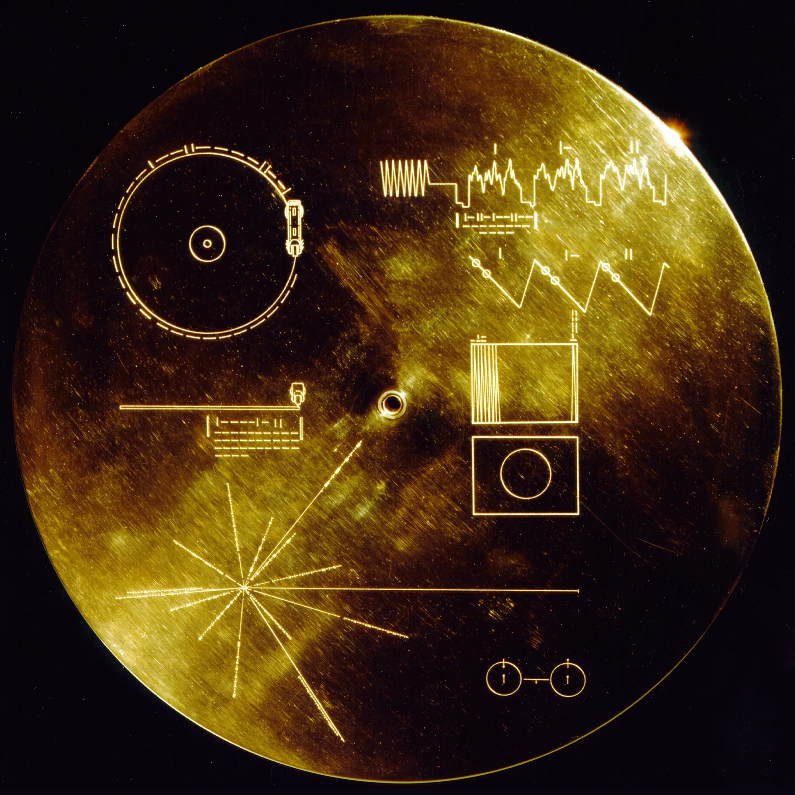 Voyager Golden Record cover engraved with pulsar map, playback instructions and hydrogen atom diagram