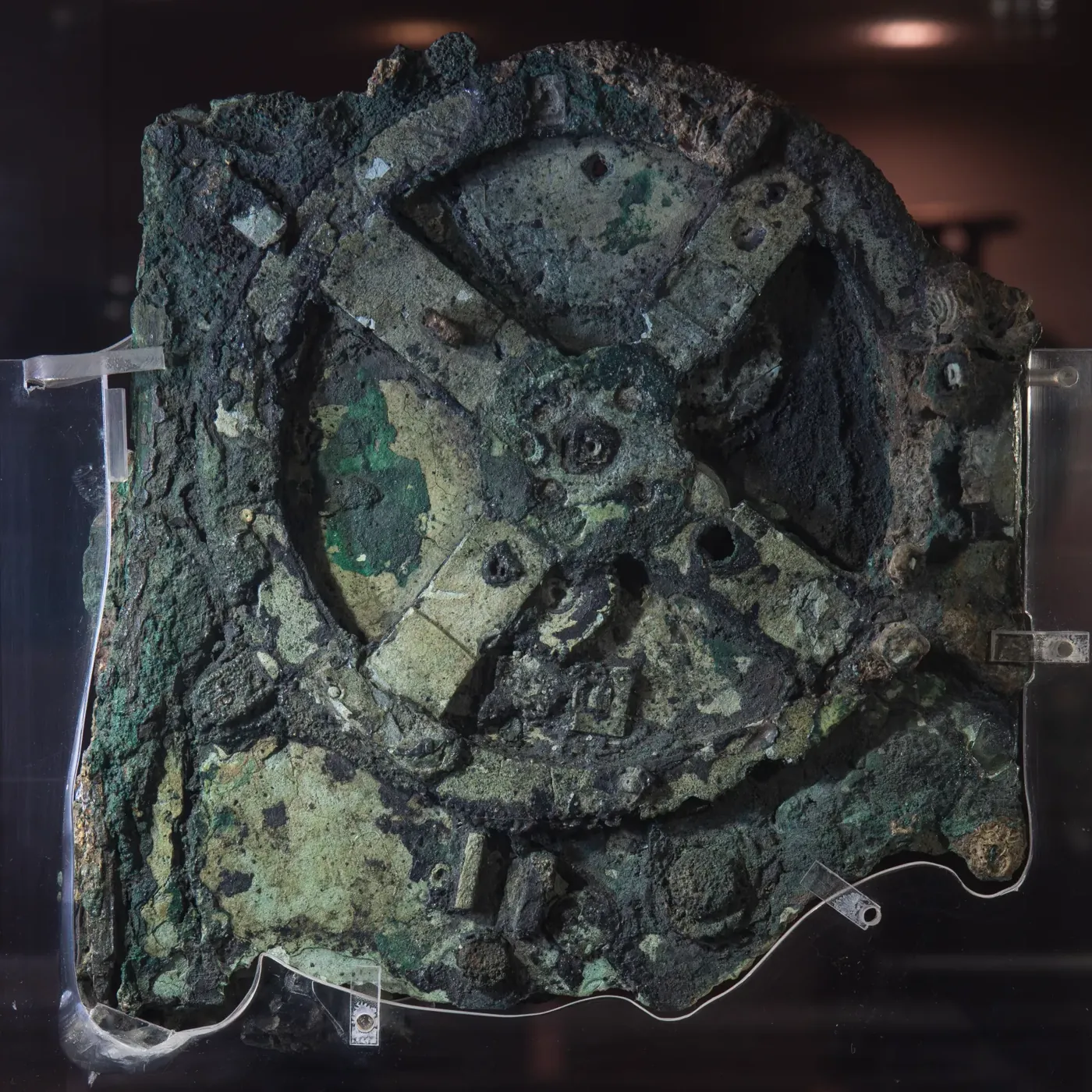 Fragment A of the Antikythera Mechanism showing the corroded bronze gears of the world's oldest known analogue computer recovered from a Greek shipwreck.